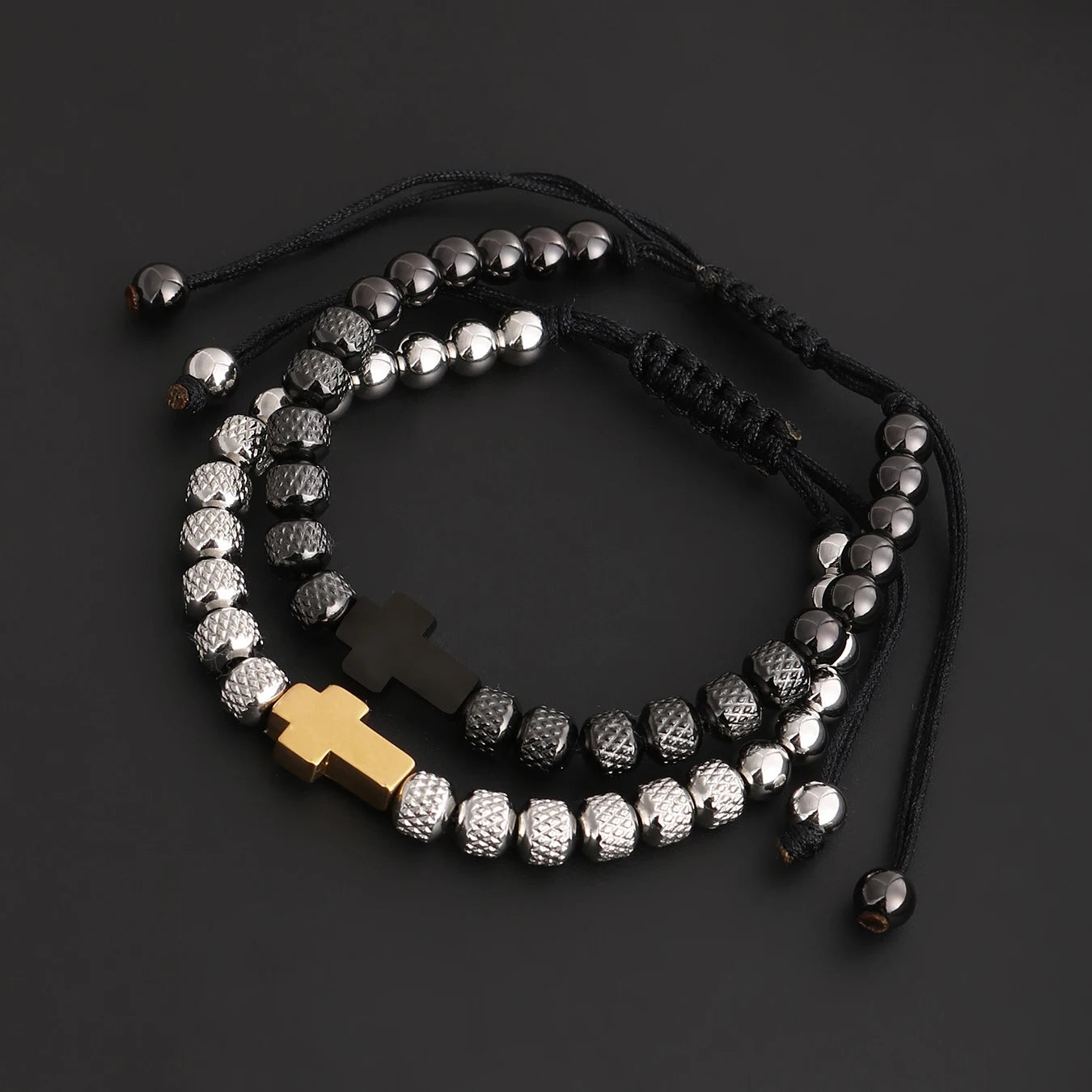 Bracelet with silver beads and a gold cross on a dark background