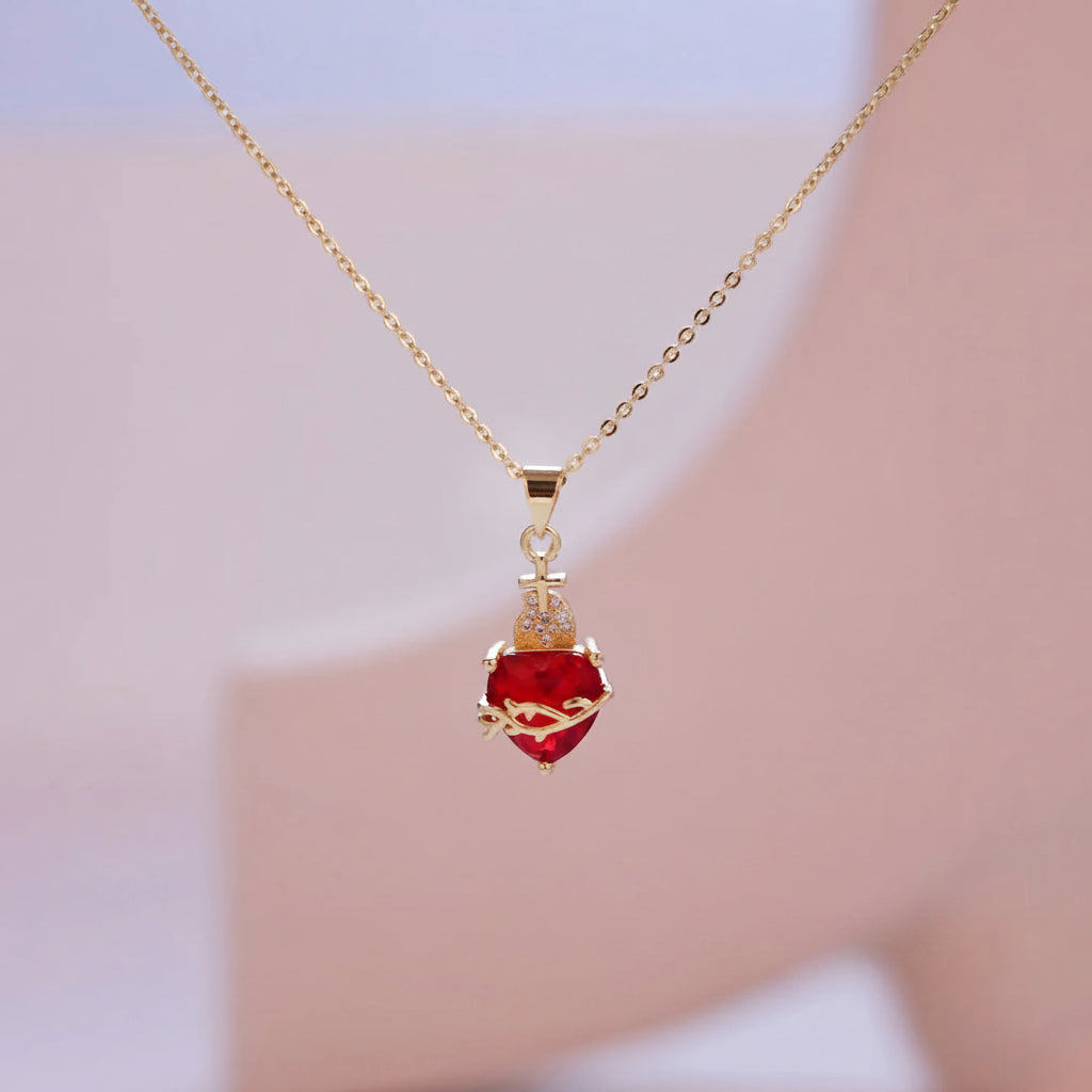 Necklace with a red heart pendant on a blurred background